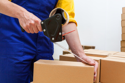 Closeup of a worker hands packing a box